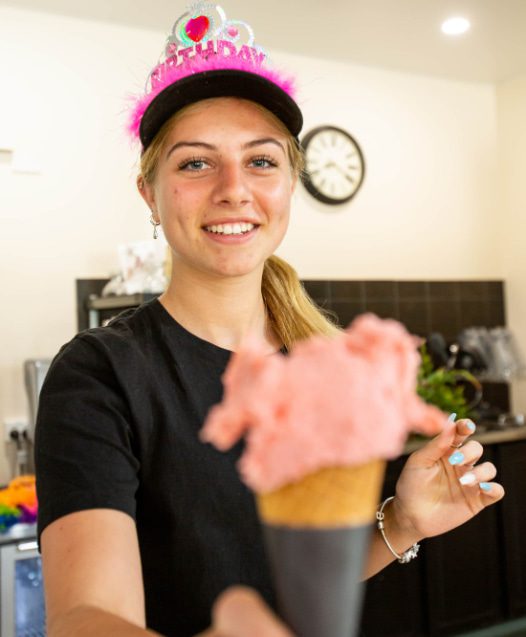 Young woman handing you an icecream