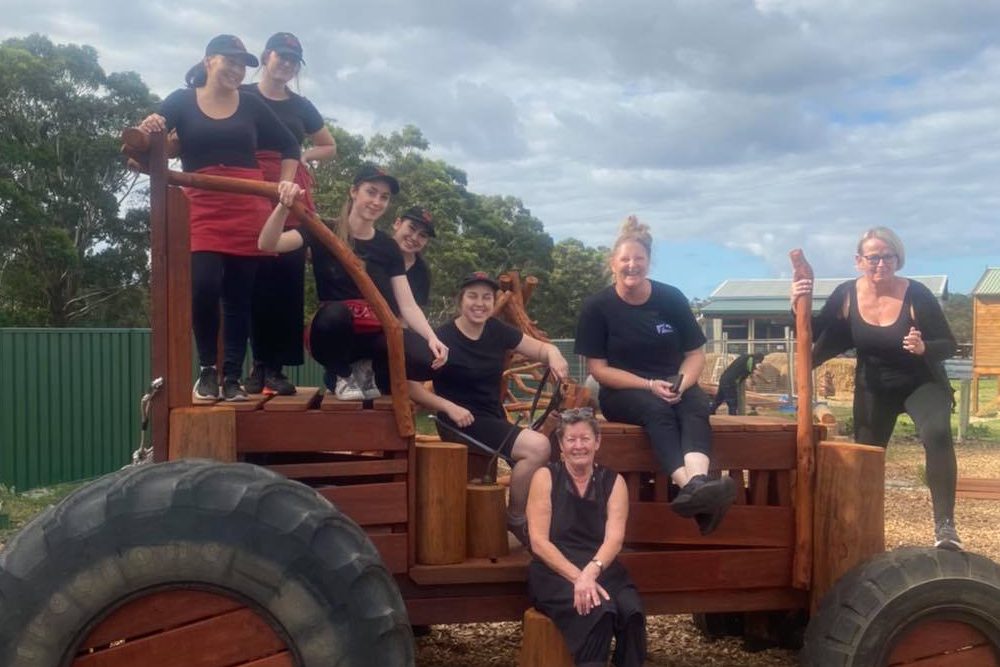The cafe staff on a playground tractor